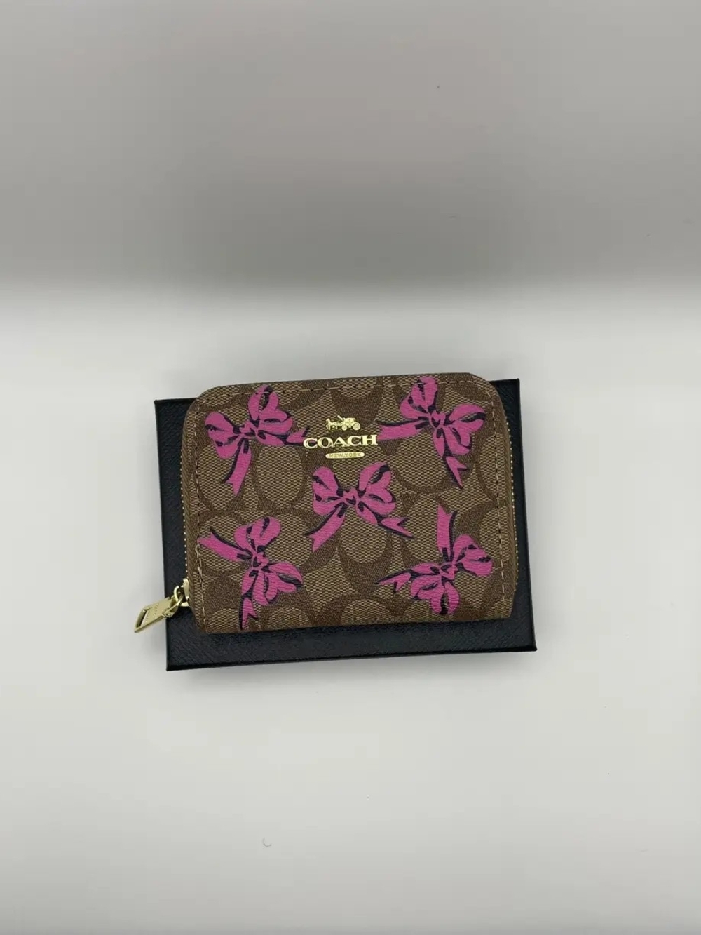Coach Brown Signature Zip Wallet with Pink Bow Motif
